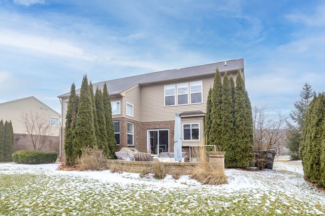 view of snow covered rear of property