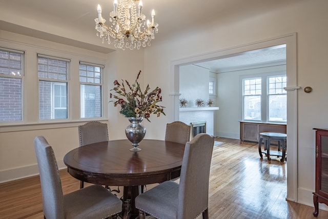 dining room featuring a fireplace and light wood-type flooring