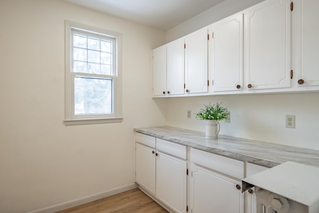 laundry room with light hardwood / wood-style floors