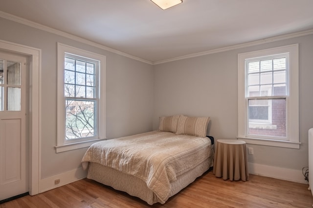 bedroom featuring crown molding and light wood-type flooring