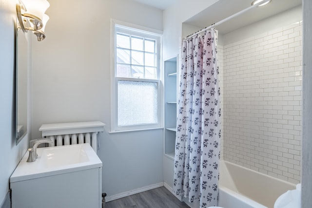 bathroom featuring vanity, radiator heating unit, wood-type flooring, and shower / bath combo with shower curtain