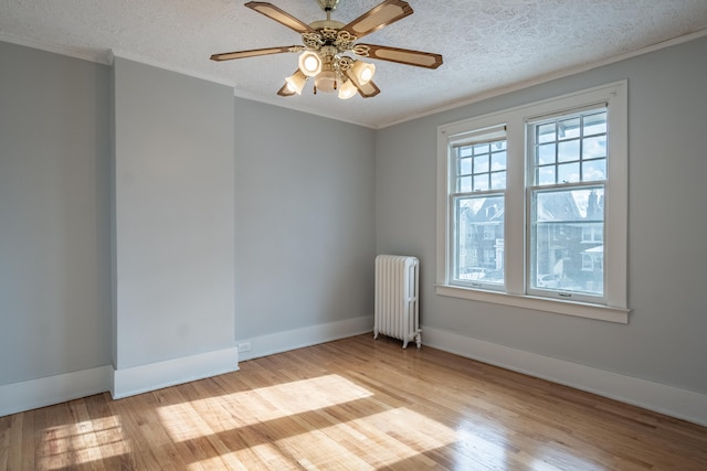 unfurnished room with radiator heating unit, ornamental molding, a textured ceiling, and light wood-type flooring