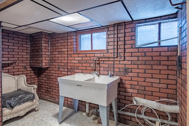 bathroom featuring brick wall