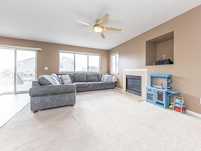 living room with ceiling fan and carpet