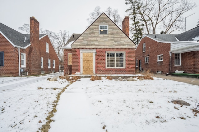 view of snow covered rear of property