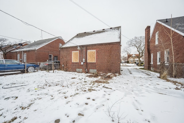 view of snow covered rear of property