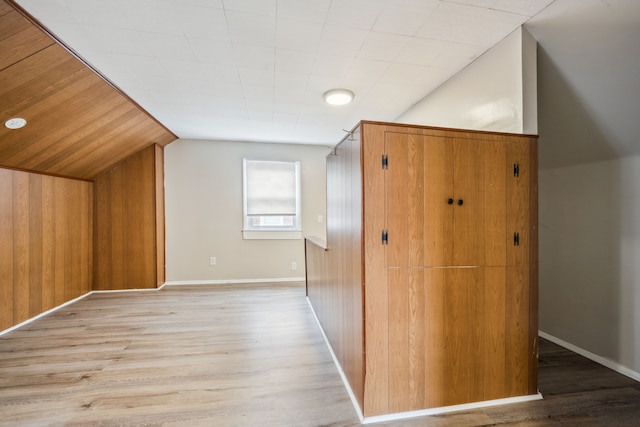 bonus room featuring light hardwood / wood-style flooring and vaulted ceiling