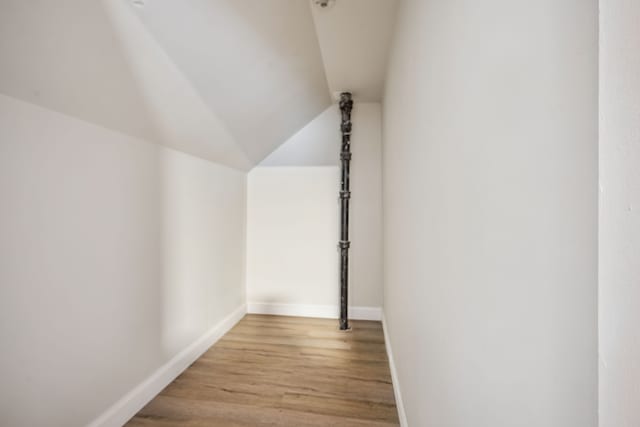 interior space featuring light hardwood / wood-style floors and vaulted ceiling