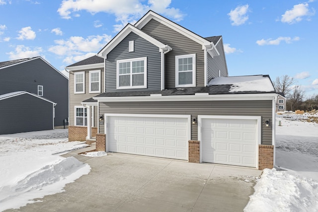 traditional-style home with a garage, brick siding, and driveway