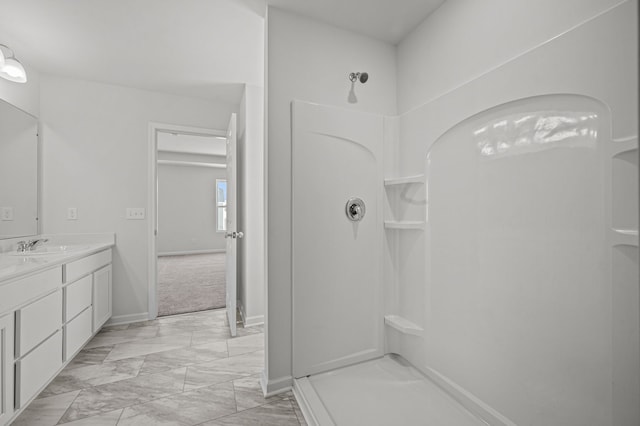 full bath featuring a shower, baseboards, marble finish floor, and vanity