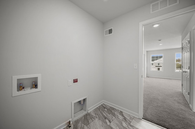 clothes washing area with washer hookup, laundry area, baseboards, and visible vents