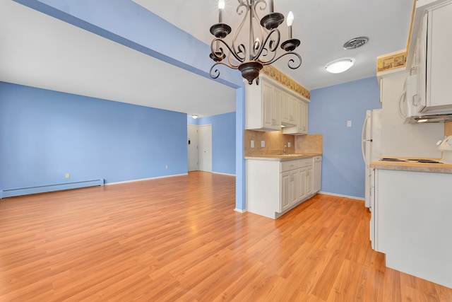 kitchen with white cabinetry, an inviting chandelier, backsplash, pendant lighting, and a baseboard heating unit