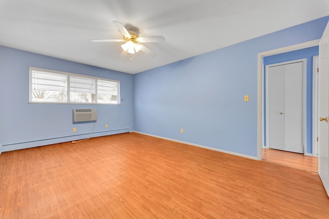 empty room featuring baseboard heating, ceiling fan, light hardwood / wood-style floors, and a wall unit AC