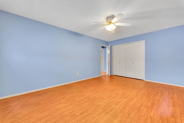 unfurnished bedroom with a closet, ceiling fan, and light wood-type flooring