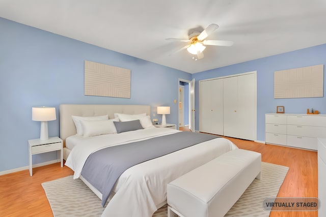 bedroom with light hardwood / wood-style floors, ceiling fan, and a closet