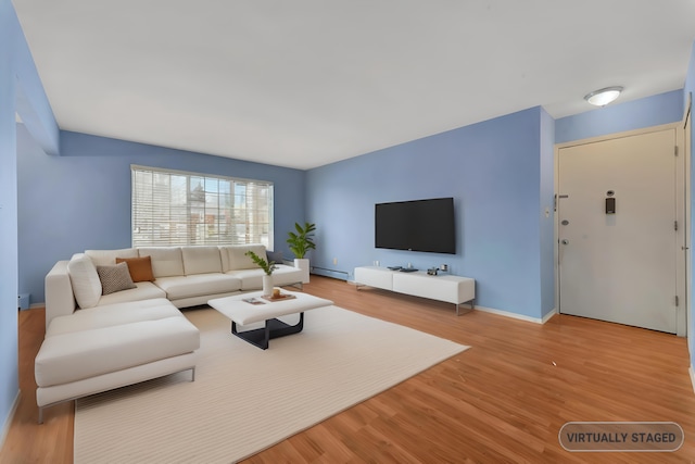 living room featuring light hardwood / wood-style floors and baseboard heating