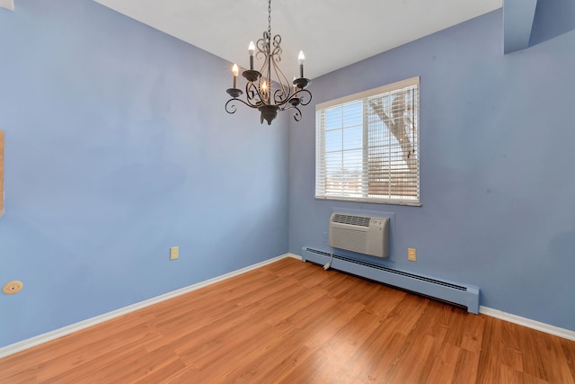 empty room featuring a wall mounted air conditioner, a baseboard radiator, a chandelier, and light wood-type flooring