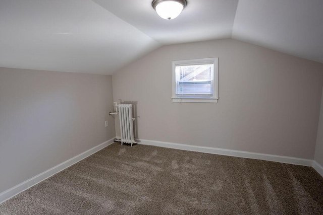 additional living space with lofted ceiling, carpet flooring, and radiator heating unit