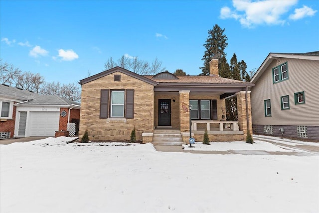 view of front of property featuring a garage and a porch