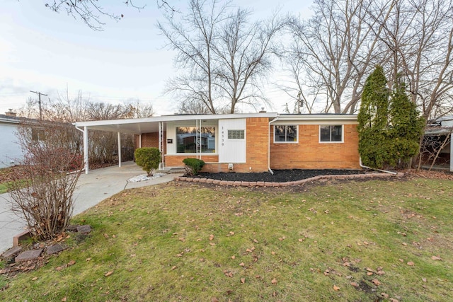 ranch-style home featuring a carport and a front yard