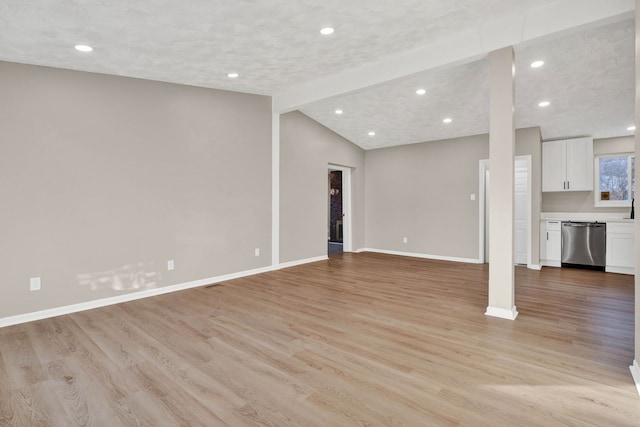 unfurnished living room featuring lofted ceiling and light hardwood / wood-style flooring