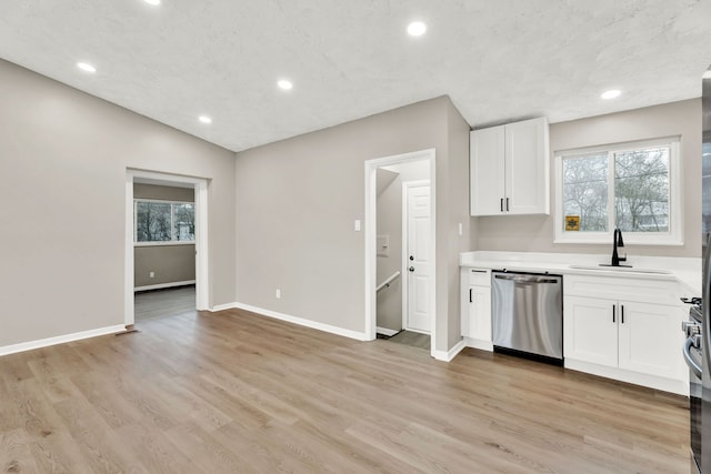 kitchen with white cabinetry, stainless steel appliances, light hardwood / wood-style floors, and sink