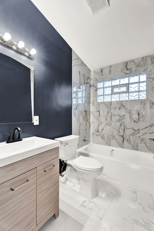 full bathroom featuring tiled shower / bath combo, vanity, and toilet