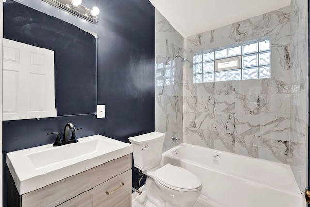 full bathroom with tiled shower / bath, vanity, and toilet