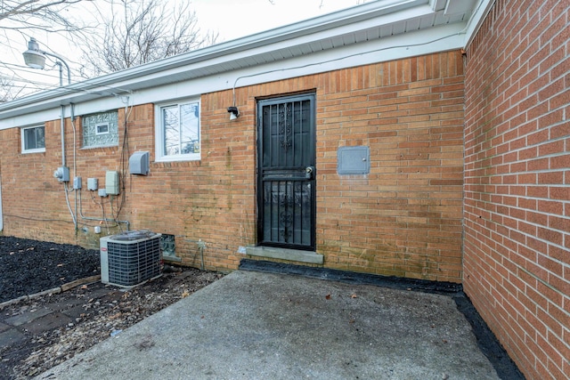 property entrance featuring cooling unit and a patio