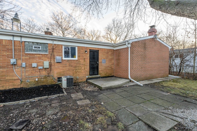 rear view of house featuring a patio and central air condition unit