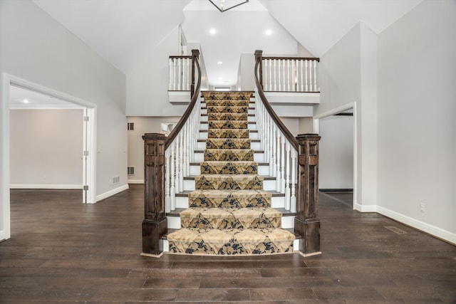 31265 Woodside Dr, Franklin, MI 48025 - staircase featuring high vaulted ceiling, baseboards, wood-type flooring, and visible vents