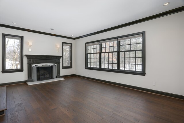 31265 Woodside Dr, Franklin, MI 48025 - unfurnished living room with crown molding, a healthy amount of sunlight, baseboards, a fireplace with raised hearth, and dark wood finished floors