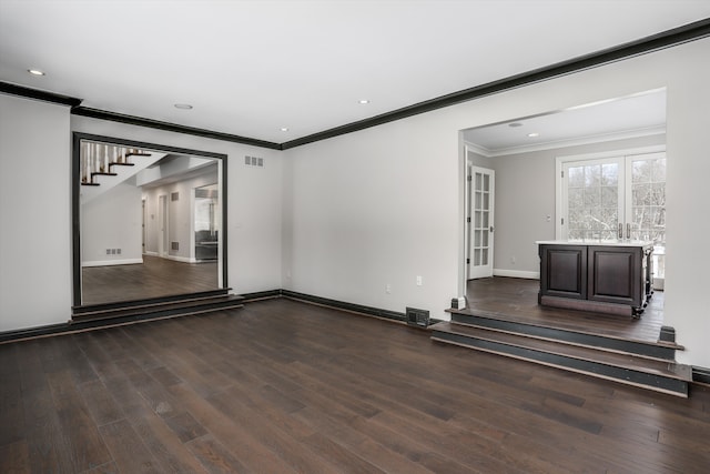 31265 Woodside Dr, Franklin, MI 48025 - empty room with dark wood-style flooring, visible vents, and ornamental molding
