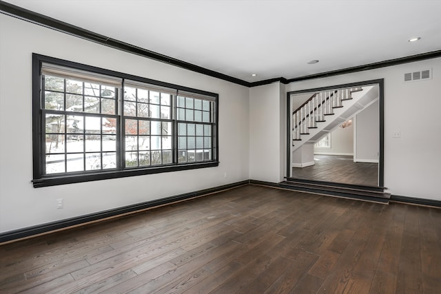 31265 Woodside Dr, Franklin, MI 48025 - empty room featuring visible vents, ornamental molding, baseboards, stairway, and dark wood-type flooring