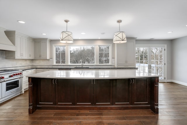 31265 Woodside Dr, Franklin, MI 48025 - kitchen with a sink, designer range, premium range hood, a center island, and decorative backsplash