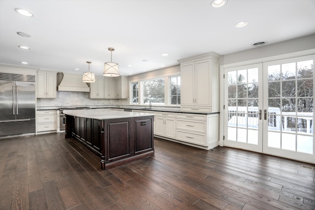 31265 Woodside Dr, Franklin, MI 48025 - kitchen with recessed lighting, dark wood-type flooring, custom range hood, backsplash, and stainless steel appliances