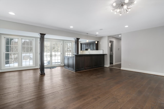 31265 Woodside Dr, Franklin, MI 48025 - unfurnished living room with recessed lighting, baseboards, ornate columns, and dark wood-type flooring