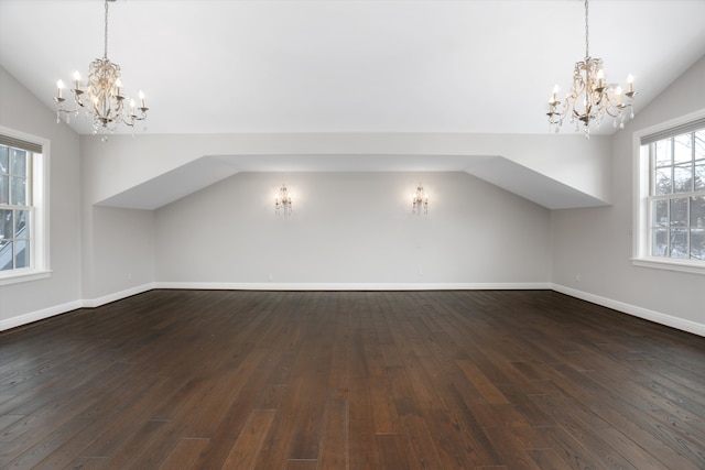 31265 Woodside Dr, Franklin, MI 48025 - additional living space with an inviting chandelier, dark wood finished floors, and vaulted ceiling