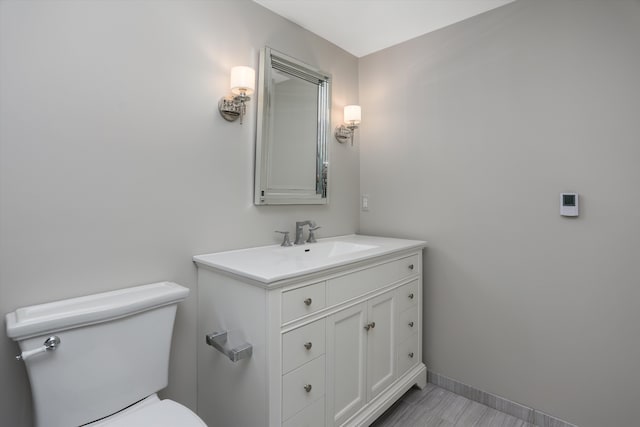 31265 Woodside Dr, Franklin, MI 48025 - half bathroom featuring toilet, baseboards, and vanity