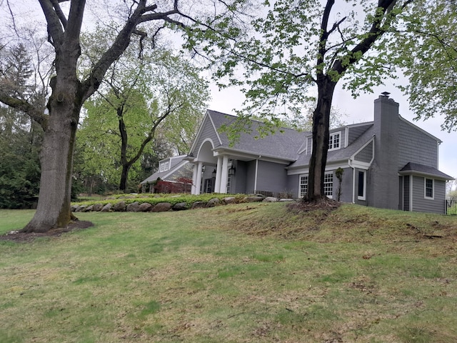 31265 Woodside Dr, Franklin, MI 48025 - view of side of home with a lawn, a chimney, and a shingled roof