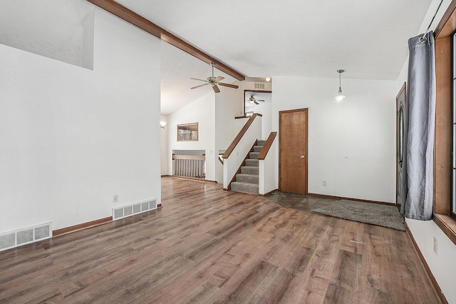 unfurnished living room featuring vaulted ceiling with beams, hardwood / wood-style floors, and ceiling fan