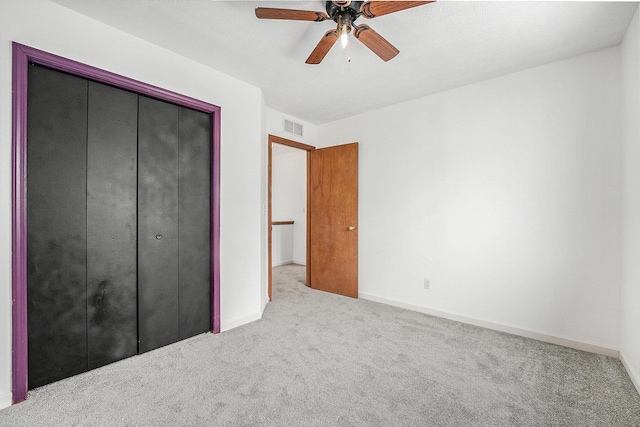 unfurnished bedroom featuring carpet floors, ceiling fan, and a closet