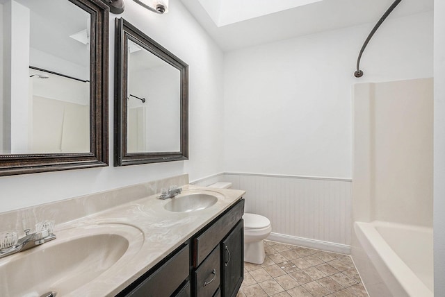 full bathroom with bathtub / shower combination, vanity, toilet, and tile patterned flooring