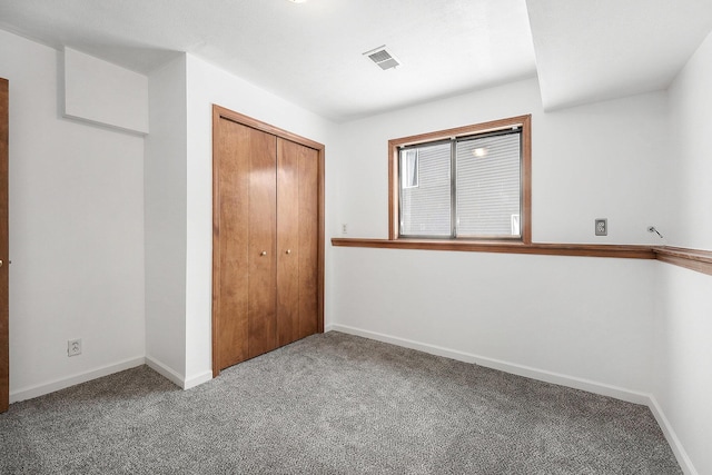 unfurnished bedroom featuring a closet and carpet