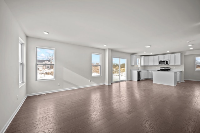 unfurnished living room featuring dark hardwood / wood-style floors