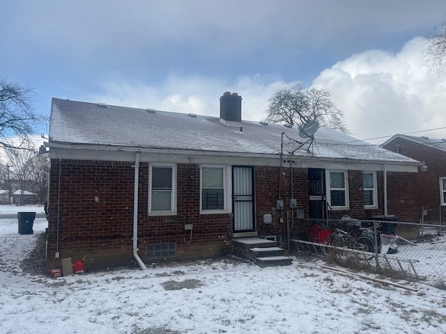 view of snow covered rear of property