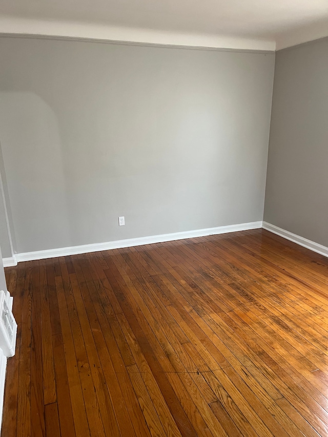 unfurnished room with hardwood / wood-style floors