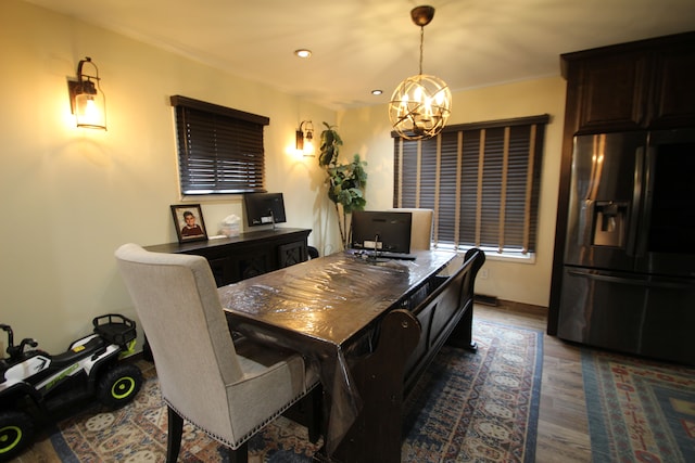 dining space with dark hardwood / wood-style floors and a notable chandelier