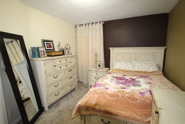 bedroom featuring light colored carpet