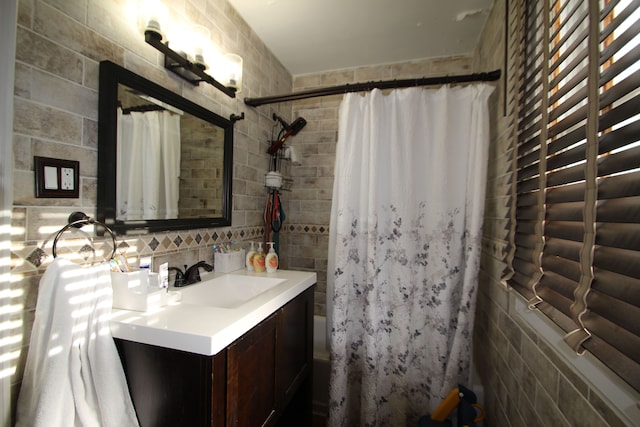 bathroom featuring tasteful backsplash, vanity, and shower / bath combination with curtain